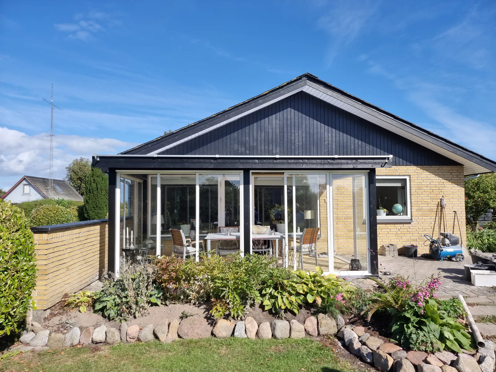 Glasveranda med store vinduer og glasdøre monteret af CBV Byg